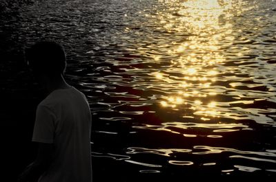 Rear view of man swimming in sea