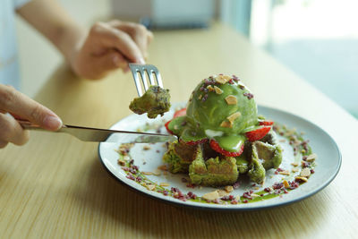 Midsection of person having food in plate