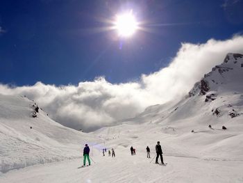 Tourists on snow covered mountain