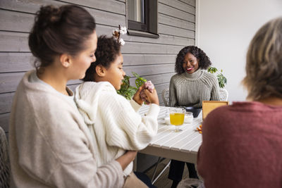 Family sitting at table outdoors