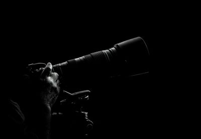 Close-up of man against black background