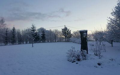 Snow covered landscape against sky