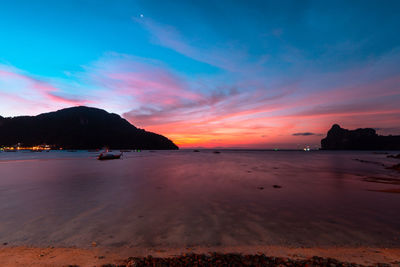 Scenic view of sea against romantic sky at sunset