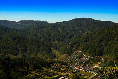 High angle view of landscape against blue sky