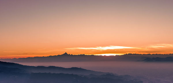 Scenic view of silhouette mountains against sky during sunset