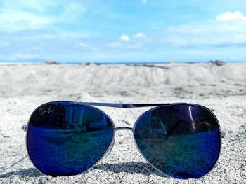 Close-up of blue water on beach against sky