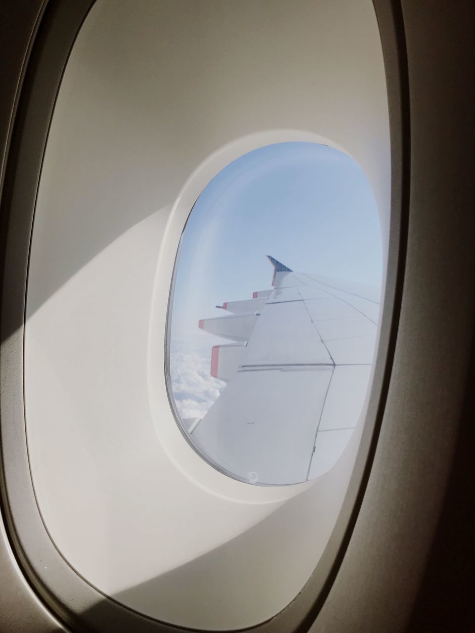 AIRPLANE WING SEEN THROUGH WINDOW