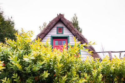 Low angle view of yellow house against sky