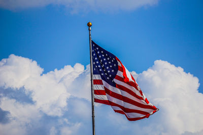 Low angle view of american flag against the sky