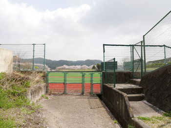 View of soccer field against cloudy sky