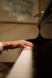 Close-up of hands playing piano