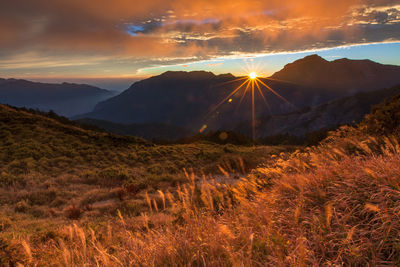 Scenic view of landscape against sky at sunset