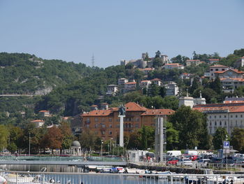 Buildings in town against clear sky