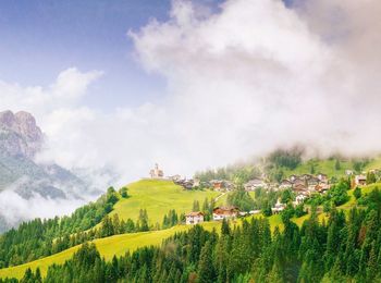 Scenic view of field against cloudy sky