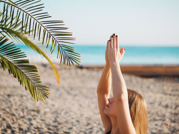 Woman doing yoga at beach