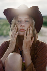 Portrait of young woman wearing hat