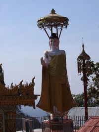 Low angle view of statue of temple against sky