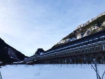 Snow covered built structure against sky