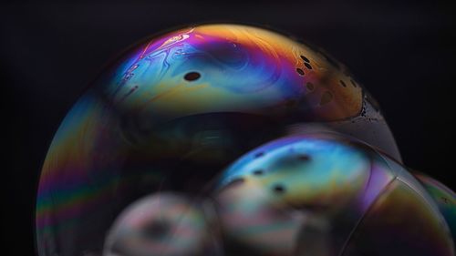 Close-up of bubbles over black background