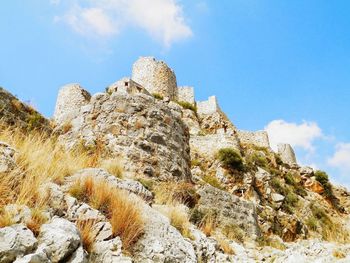 Low angle view of rock formation against blue sky