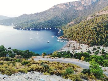 High angle view of sea and mountains against sky