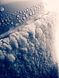 Aerial view of sea seen through airplane window