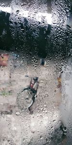 Full frame shot of wet glass window in rainy season