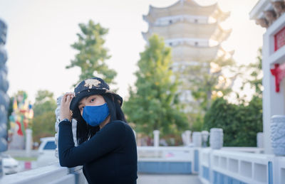 Portrait of young woman wearing face mask for protection from cold and flu and virus 