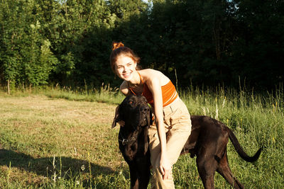 Young woman riding horse on field