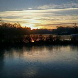 Scenic view of lake at sunset