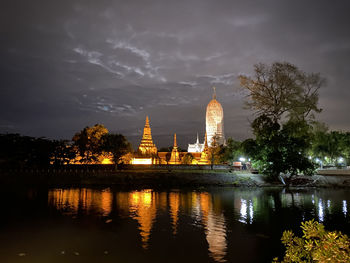 Night view across river to temple in ayutthaya, thailand