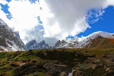 Scenic view of mountains against cloudy sky