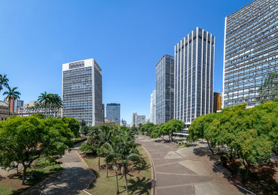 Buildings in city against clear sky