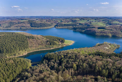 High angle view of lake and trees against sky