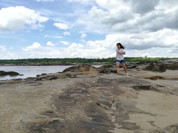 Man standing on beach against sky