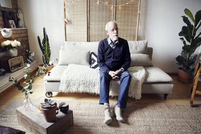 Senior man sitting in living room