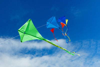 Low angle view of kite against blue sky