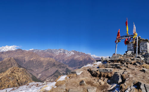 Panoramic view of rocks and mountains against blue sky