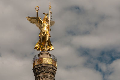 Low angle view of statue against cloudy sky