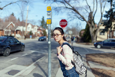 Portrait of woman with umbrella on city street