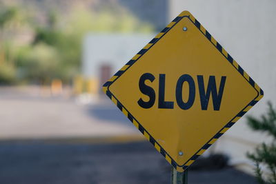 Close-up of slow sign on the road