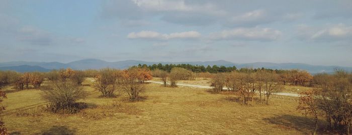 Scenic view of mountains against cloudy sky