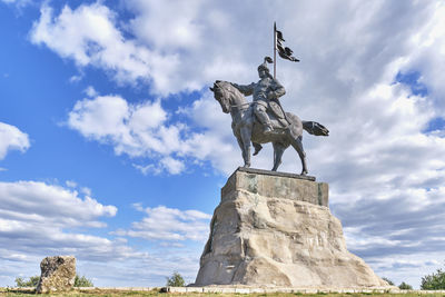 Low angle view of statue against sky