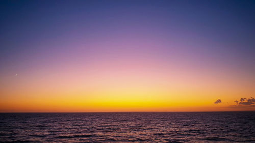 Scenic view of sea against romantic sky at sunset