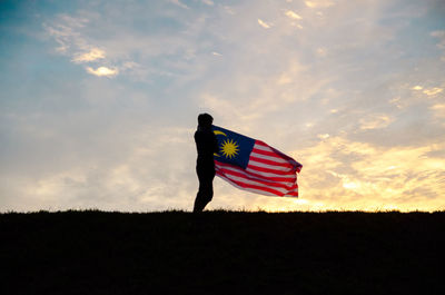 Low angle view of american flag against sky
