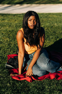 Young woman sitting on grass