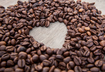 Close-up of heart shape roasted coffee beans on table