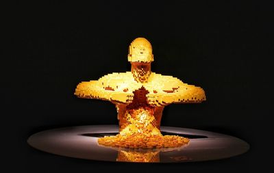 Close-up of illuminated statue against black background