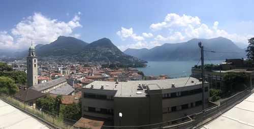 High angle view of townscape by sea against sky