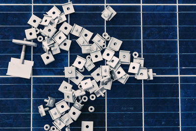 Top view of various metal elements placed on modern solar batteries in industrial area of factory